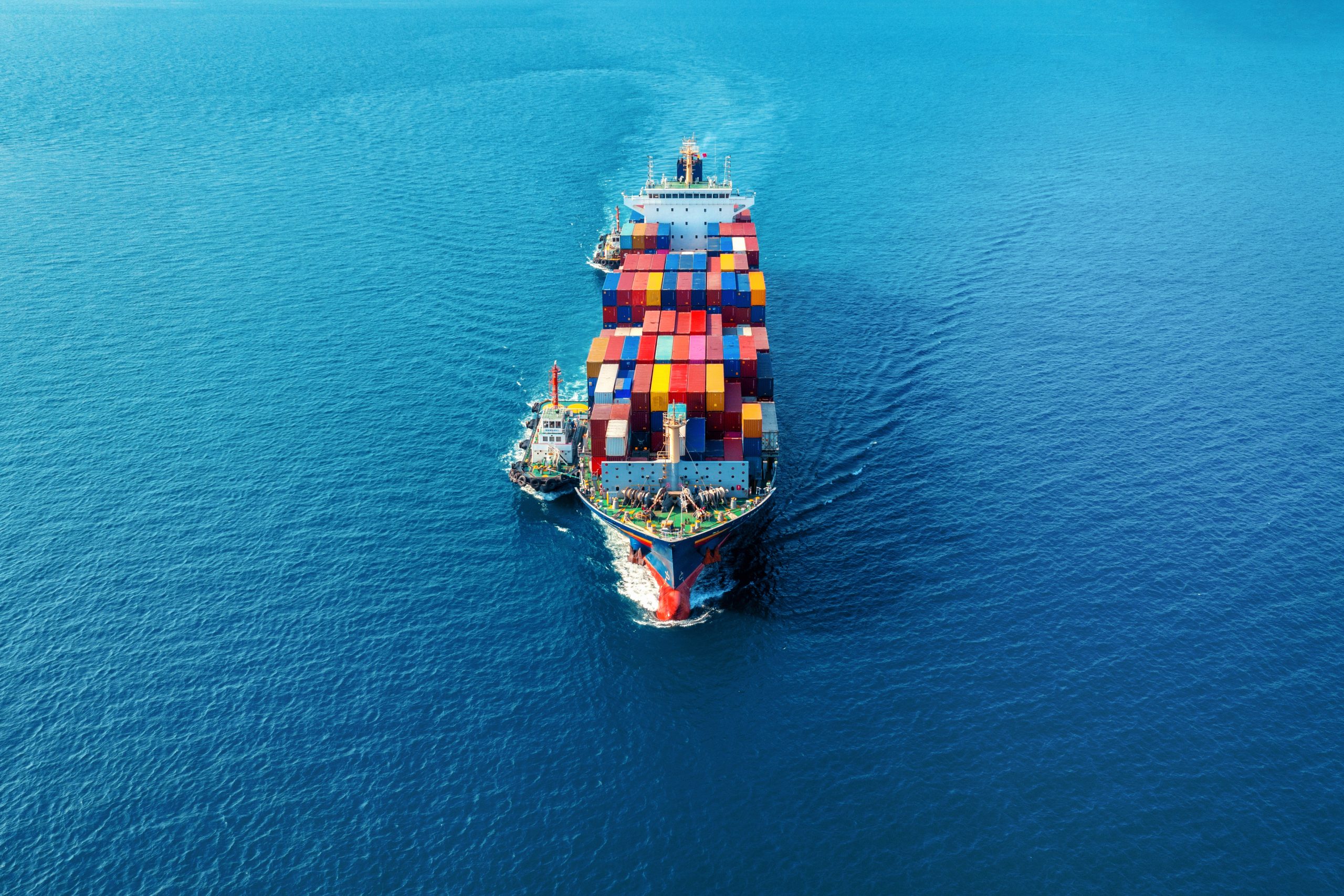 Aerial view of cargo ship with cargo container on sea.